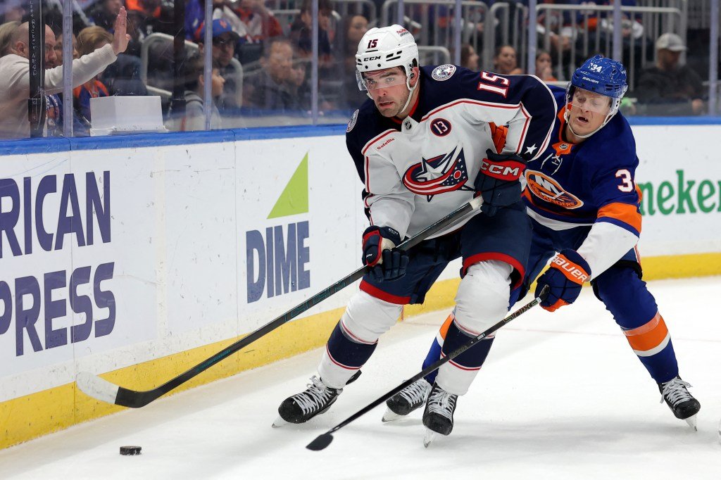 Adam Boqvist fights for the puck during the Islanders' shootout loss to the Blue Jackets on March 24.